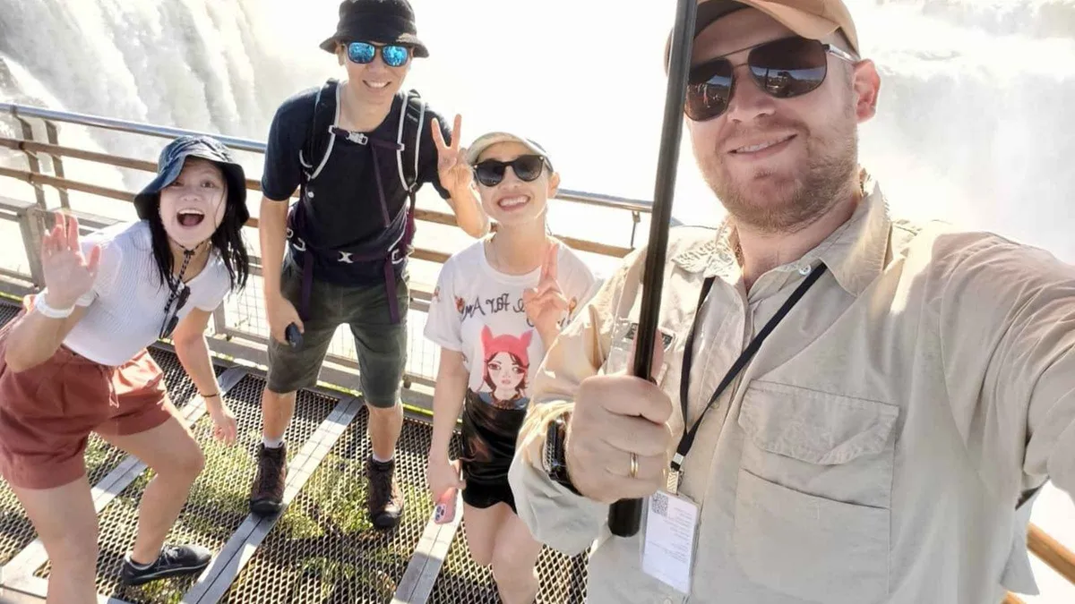 Private guide with travellers on the Brazilian panorama walkway during a two-day Iguazu Falls boat tour